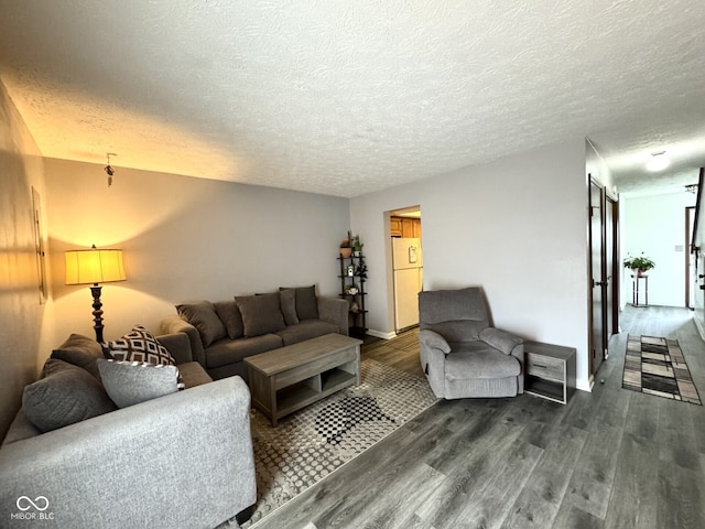 7445 Melanie Ln, Indianapolis, IN 46217 - living room with dark wood-style flooring, a textured ceiling, and baseboards