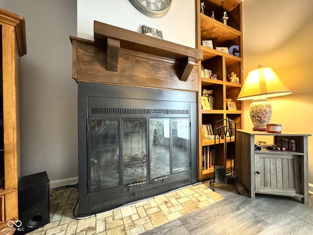 7445 Melanie Ln, Indianapolis, IN 46217 - detailed view of baseboards and a glass covered fireplace