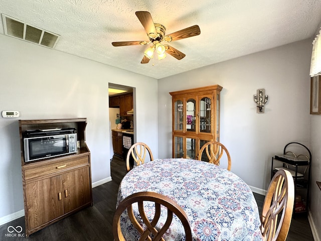 7445 Melanie Ln, Indianapolis, IN 46217 - dining room with baseboards, ceiling fan, dark wood-style floors, and a textured ceiling