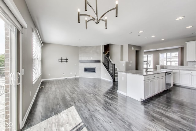 13050 Grand Vue Dr, Carmel, IN 46032 - kitchen with a sink, dishwasher, a tile fireplace, baseboards, and wood finished floors