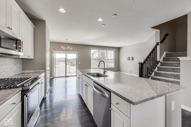 13050 Grand Vue Dr, Carmel, IN 46032 - kitchen featuring stainless steel appliances, a sink, white cabinets, a chandelier, and recessed lighting