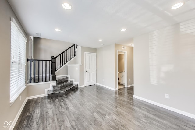 13050 Grand Vue Dr, Carmel, IN 46032 - living area featuring plenty of natural light, wood finished floors, baseboards, stairs, and recessed lighting