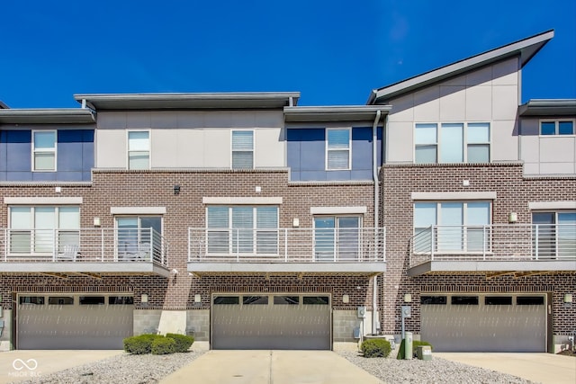 13050 Grand Vue Dr, Carmel, IN 46032 - view of front facade featuring a garage, driveway, and brick siding