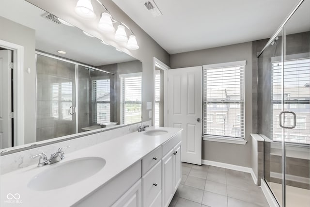 13050 Grand Vue Dr, Carmel, IN 46032 - full bath featuring tile patterned flooring, double vanity, a stall shower, and baseboards