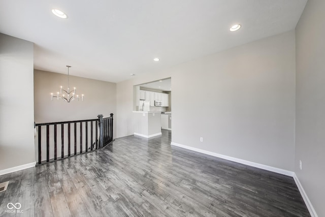 13050 Grand Vue Dr, Carmel, IN 46032 - spare room featuring dark wood-style floors, a chandelier, baseboards, and recessed lighting