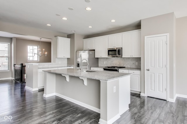 13050 Grand Vue Dr, Carmel, IN 46032 - kitchen featuring stainless steel appliances, decorative backsplash, a sink, a chandelier, and a kitchen island with sink