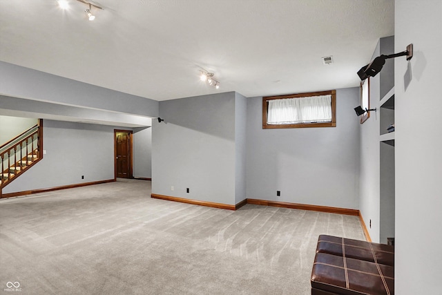 1850 Longest Dr, Franklin, IN 46131 - below grade area featuring rail lighting, carpet flooring, stairs, and baseboards