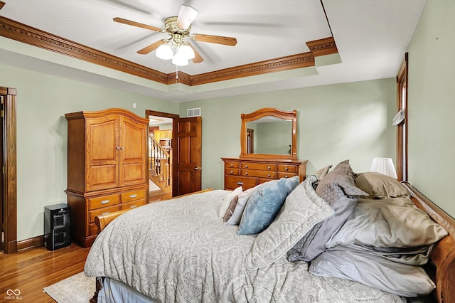 1850 Longest Dr, Franklin, IN 46131 - bedroom featuring a raised ceiling, wood finished floors, baseboards, ceiling fan, and ornamental molding