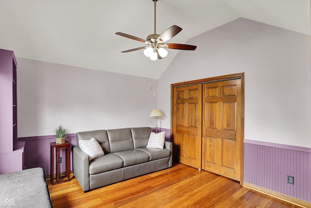 1850 Longest Dr, Franklin, IN 46131 - living room featuring wainscoting, ceiling fan, light wood finished floors, and high vaulted ceiling