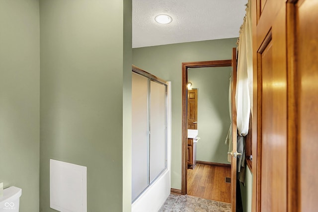 1850 Longest Dr, Franklin, IN 46131 - bathroom featuring a shower with shower door, a textured ceiling, vanity, and toilet