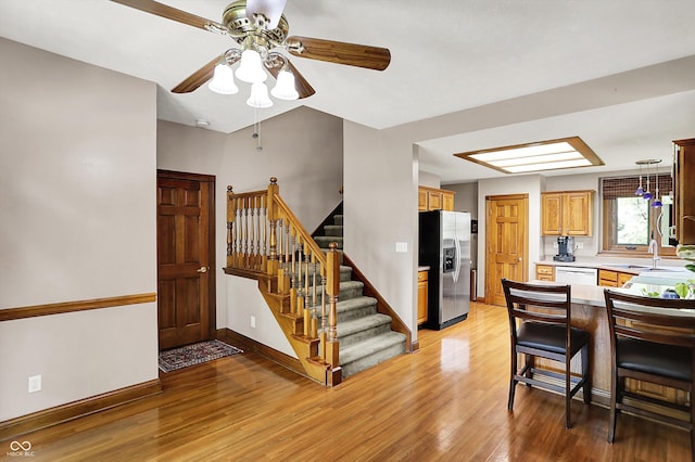 1850 Longest Dr, Franklin, IN 46131 - kitchen featuring stainless steel fridge with ice dispenser, ceiling fan, white dishwasher, light wood-type flooring, and light countertops