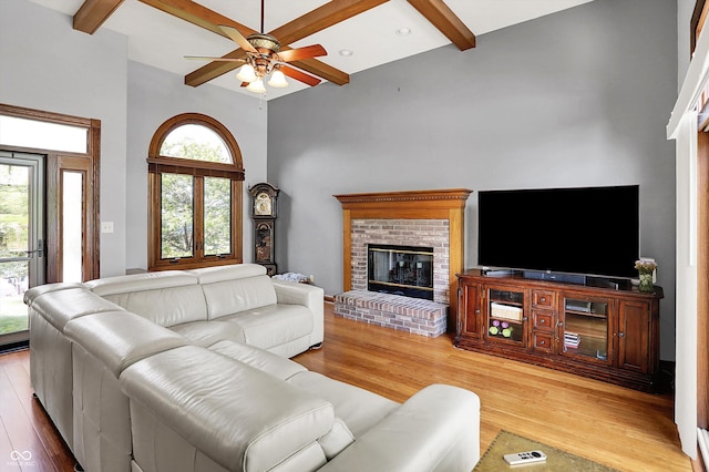 1850 Longest Dr, Franklin, IN 46131 - living area featuring a fireplace, light wood finished floors, ceiling fan, a high ceiling, and beamed ceiling