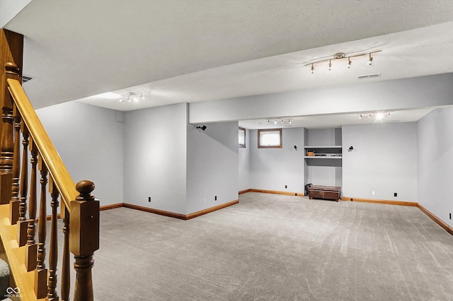 1850 Longest Dr, Franklin, IN 46131 - below grade area with carpet flooring, track lighting, baseboards, and stairs