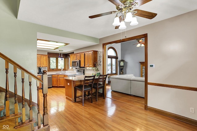 1850 Longest Dr, Franklin, IN 46131 - kitchen featuring stainless steel appliances, a sink, ceiling fan, light wood-style flooring, and brown cabinetry