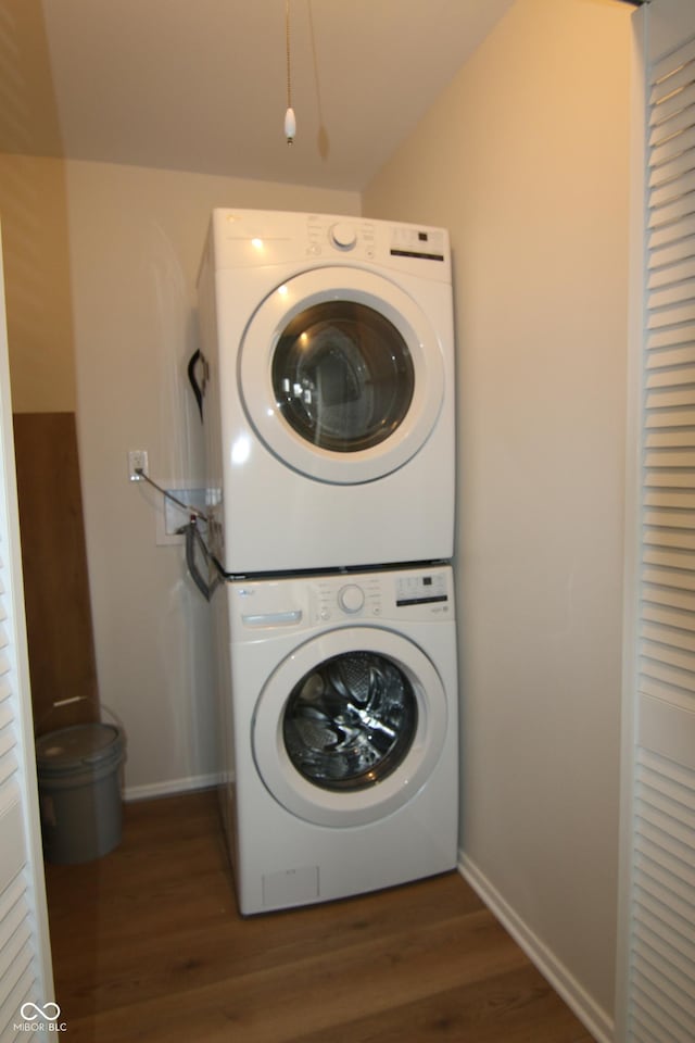 1021 Harney Dr, Lebanon, IN 46052 - laundry room with stacked washing machine and dryer, wood finished floors, and baseboards
