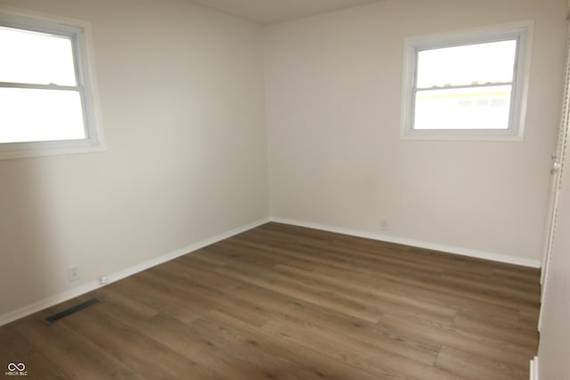 1021 Harney Dr, Lebanon, IN 46052 - empty room with plenty of natural light, wood finished floors, and baseboards