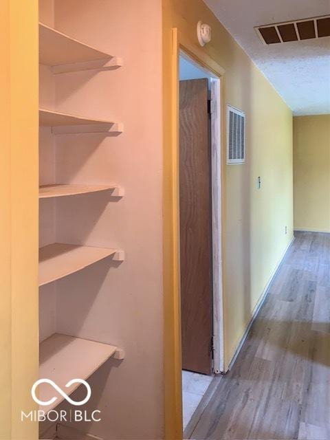 1998 Crescent St, Franklin, IN 46131 - corridor with wood finished floors, baseboards, and a textured ceiling