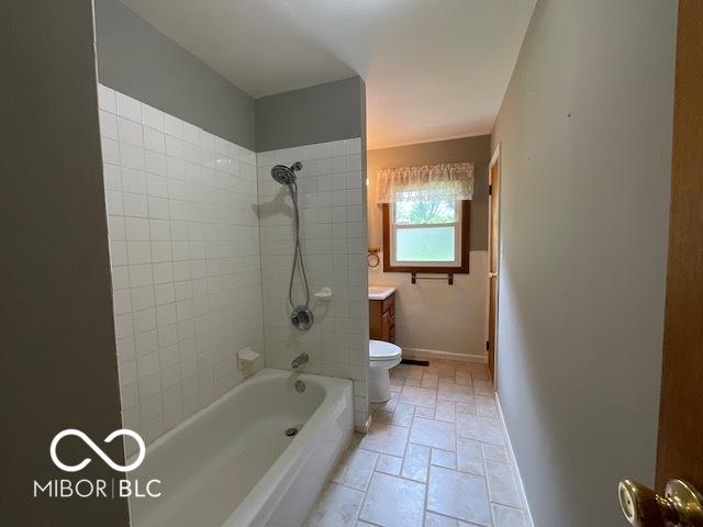 1998 Crescent St, Franklin, IN 46131 - bathroom with toilet, baseboards, shower / tub combination, vanity, and stone finish flooring