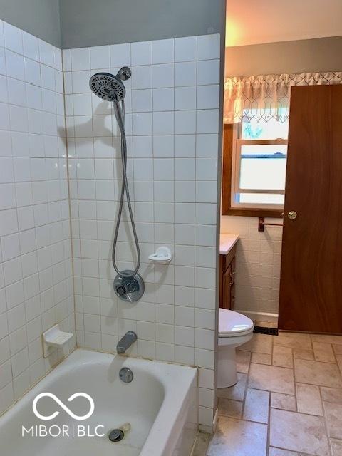 1998 Crescent St, Franklin, IN 46131 - full bathroom featuring shower / tub combination, vanity, stone finish flooring, and toilet