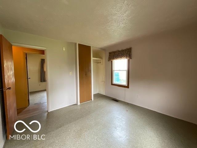 1998 Crescent St, Franklin, IN 46131 - unfurnished bedroom featuring a textured ceiling, a closet, and baseboards