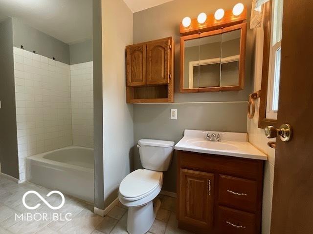 1998 Crescent St, Franklin, IN 46131 - bathroom with toilet, baseboards, vanity, tile patterned flooring, and bathing tub / shower combination