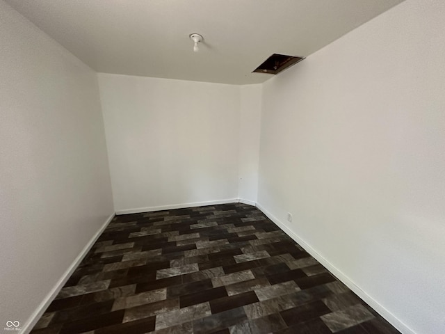 2310 E Raymond St, Indianapolis, IN 46203 - empty room with dark wood-style floors and baseboards