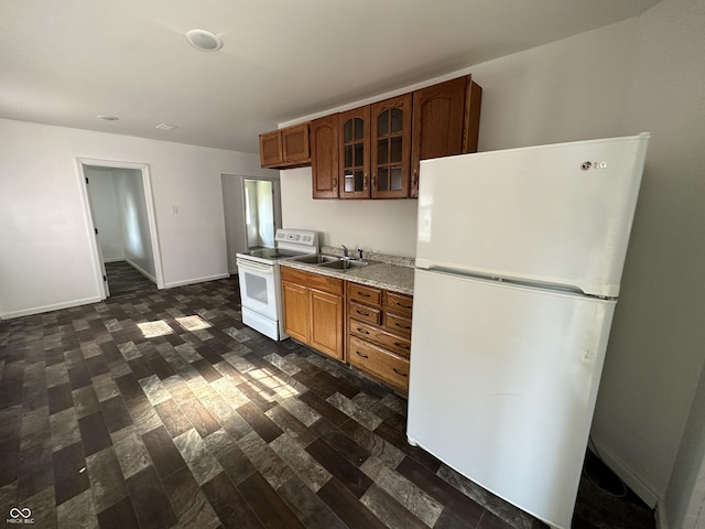 2310 E Raymond St, Indianapolis, IN 46203 - kitchen featuring white appliances, glass insert cabinets, baseboards, light countertops, and a sink