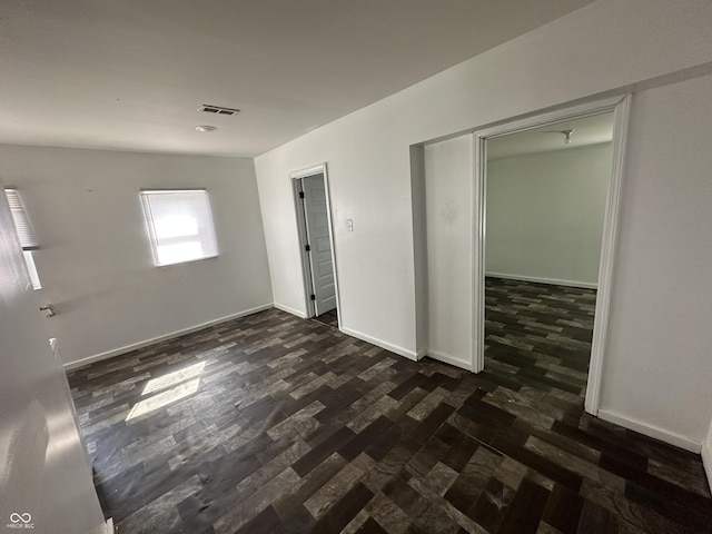 2310 E Raymond St, Indianapolis, IN 46203 - empty room with dark wood-style flooring and baseboards