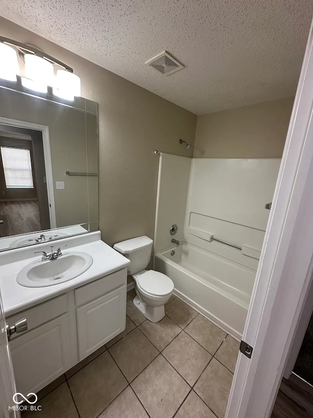 3861 Candle Berry Dr, Indianapolis, IN 46235 - bathroom featuring vanity, shower / bathtub combination, toilet, a textured ceiling, and tile patterned floors