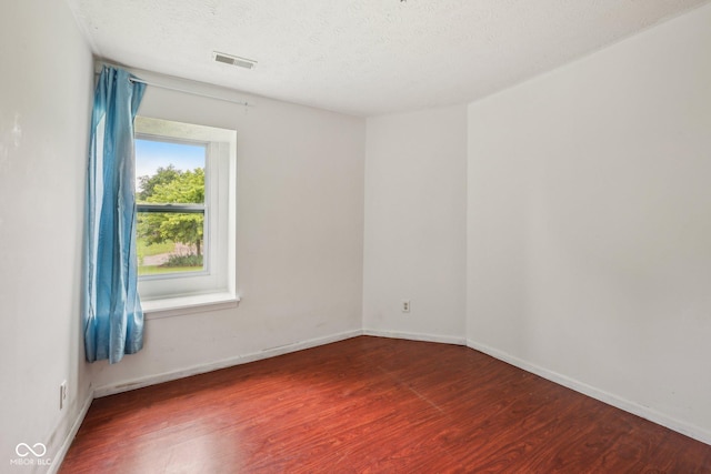 6627 Cobden Ct, Indianapolis, IN 46254 - unfurnished room with wood finished floors, baseboards, and a textured ceiling