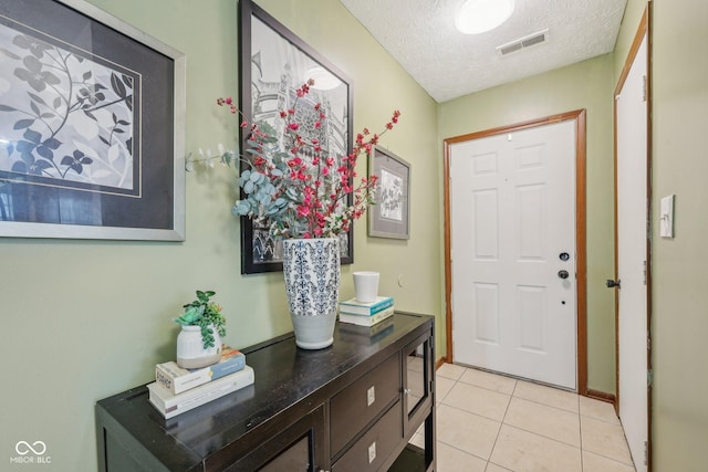 6627 Cobden Ct, Indianapolis, IN 46254 - entryway featuring a textured ceiling and light tile patterned floors