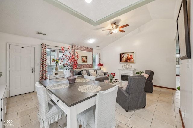 6627 Cobden Ct, Indianapolis, IN 46254 - dining room with light tile patterned floors, a ceiling fan, lofted ceiling, and a fireplace