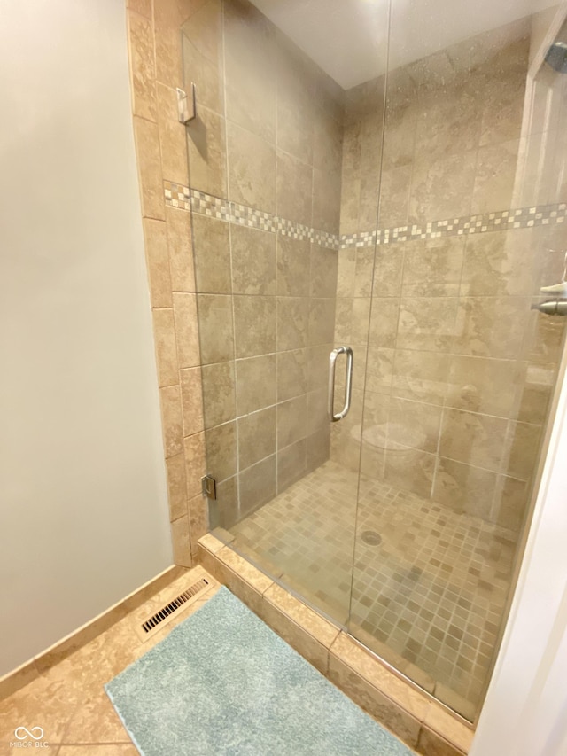 12231 Valley View Cir, Indianapolis, IN 46229 - bathroom with a shower stall, tile patterned floors, and baseboards