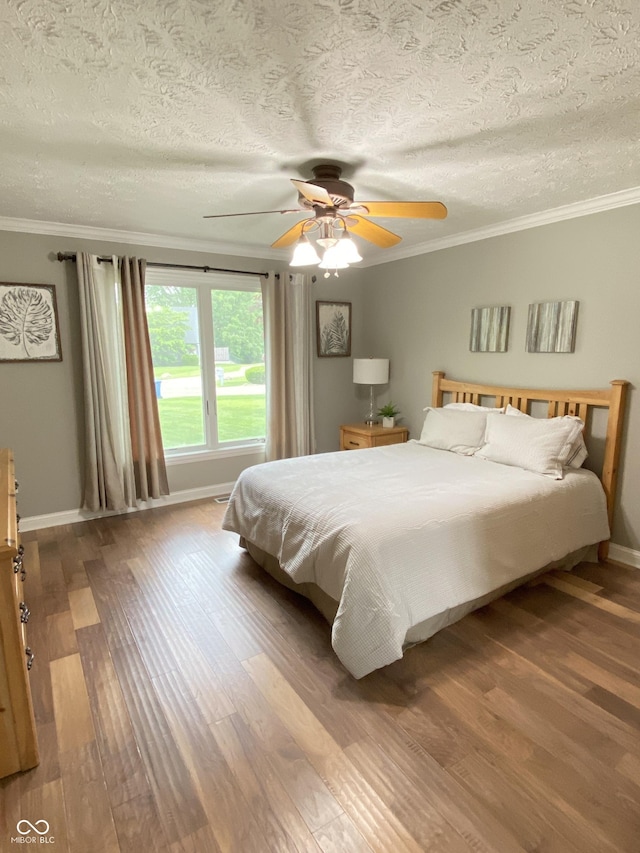 12231 Valley View Cir, Indianapolis, IN 46229 - bedroom featuring crown molding, wood finished floors, baseboards, a textured ceiling, and ceiling fan