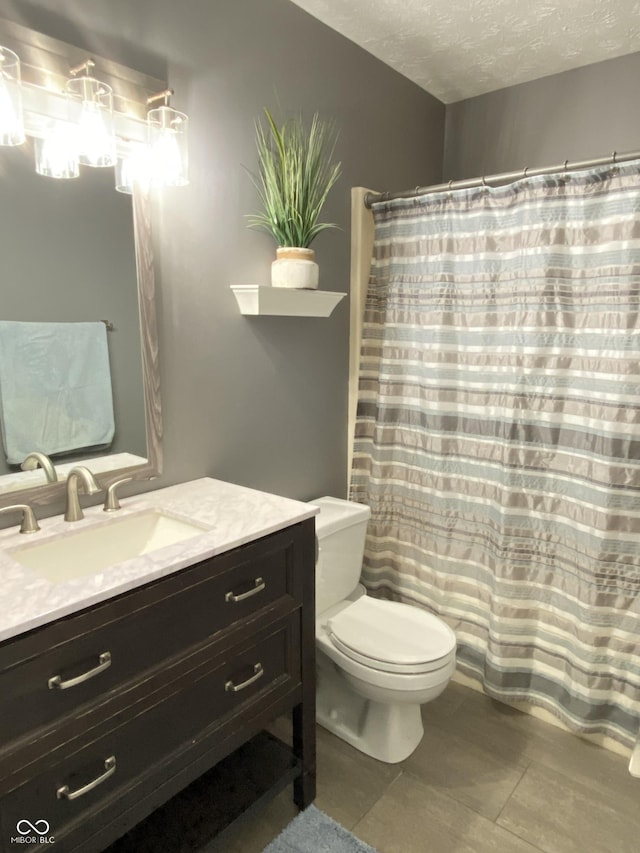 12231 Valley View Cir, Indianapolis, IN 46229 - full bath featuring toilet, vanity, a textured ceiling, a shower with curtain, and tile patterned flooring