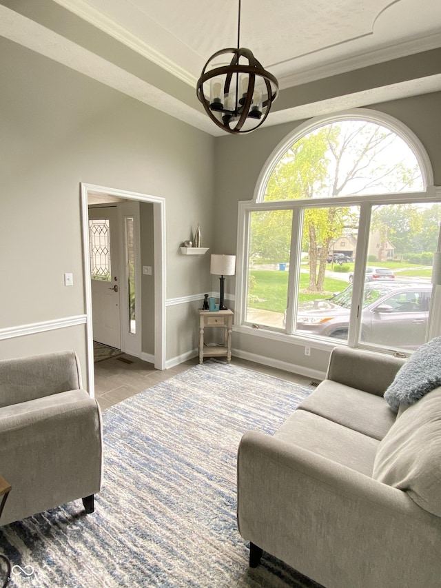 12231 Valley View Cir, Indianapolis, IN 46229 - tiled living room with a chandelier, ornamental molding, and baseboards