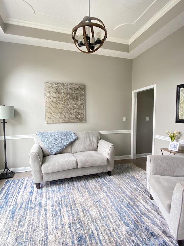 12231 Valley View Cir, Indianapolis, IN 46229 - living room with a raised ceiling, a chandelier, crown molding, wood finished floors, and baseboards