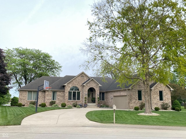 12231 Valley View Cir, Indianapolis, IN 46229 - view of front of property with brick siding, a front yard, and concrete driveway