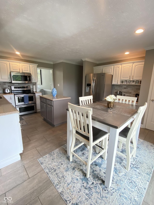 12231 Valley View Cir, Indianapolis, IN 46229 - dining space featuring ornamental molding, a textured ceiling, and recessed lighting