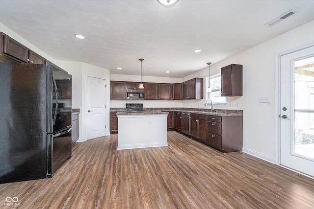 107 Elliott Ave, Trafalgar, IN 46181 - kitchen with black appliances, dark wood-style floors, a sink, dark brown cabinetry, and recessed lighting