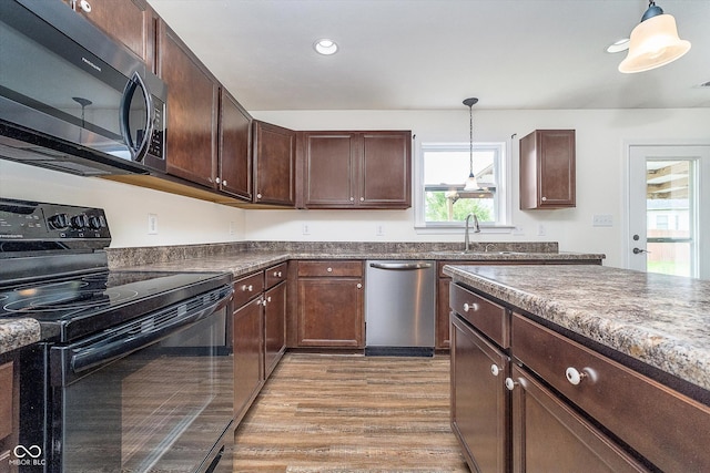 107 Elliott Ave, Trafalgar, IN 46181 - kitchen with black range with electric cooktop, stainless steel dishwasher, a sink, hanging light fixtures, and recessed lighting