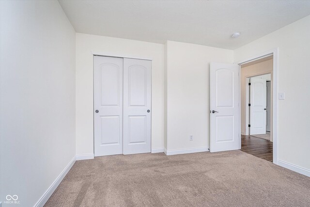 107 Elliott Ave, Trafalgar, IN 46181 - unfurnished bedroom with carpet flooring, baseboards, and a closet