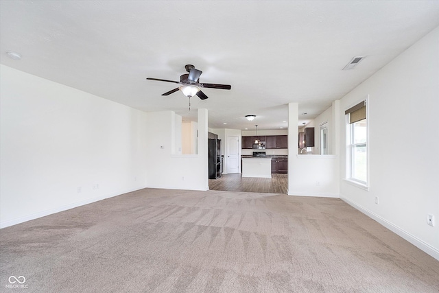 107 Elliott Ave, Trafalgar, IN 46181 - unfurnished living room featuring carpet, baseboards, and a ceiling fan