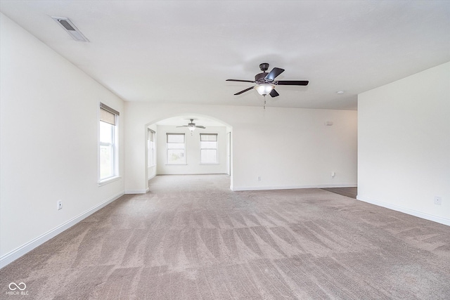 107 Elliott Ave, Trafalgar, IN 46181 - unfurnished room featuring ceiling fan, light carpet, baseboards, and arched walkways