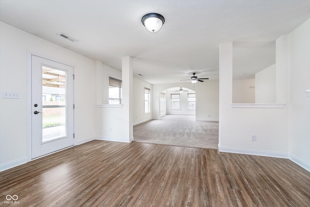 107 Elliott Ave, Trafalgar, IN 46181 - unfurnished room featuring wood finished floors, baseboards, a ceiling fan, and arched walkways
