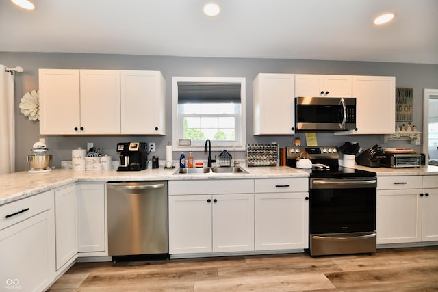 5190 N State Road 213, Windfall, IN 46076 - kitchen with stainless steel appliances, a sink, white cabinetry, recessed lighting, and light wood-style flooring
