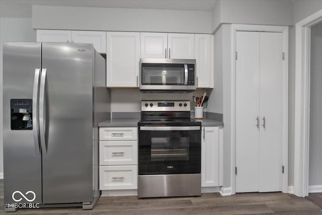 601 Woodbine, Terre Haute, IN 47803 - kitchen featuring appliances with stainless steel finishes, dark wood finished floors, and white cabinets