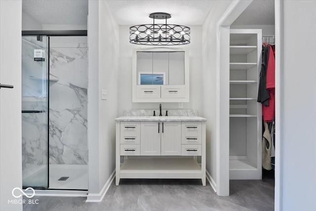 601 Woodbine, Terre Haute, IN 47803 - full bathroom featuring vanity, a marble finish shower, a spacious closet, baseboards, and a textured ceiling
