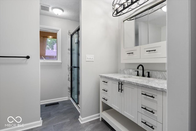 601 Woodbine, Terre Haute, IN 47803 - bathroom with a textured ceiling, vanity, baseboards, and a stall shower