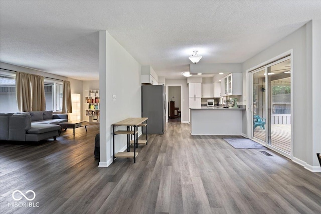 601 Woodbine, Terre Haute, IN 47803 - living room with dark wood finished floors, healthy amount of natural light, baseboards, and a textured ceiling